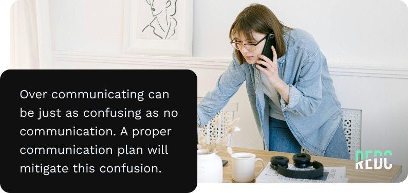 Image: a woman with brown hair and a jean shirt, standing but leaning over her laptop on her desk while talking on the phone. Text: over communicating can be just as confusing as no communication. a proper communication plan will mitigate this confusion.