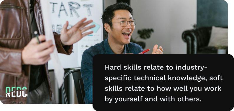 image: a man with glasses and a dark blue button-up shirt gleefully celebrates a team win  in a concerence room. Text: Hard skills are related to industry-specific technial knowledge, soft skills relate to how well you work by yourself and others.