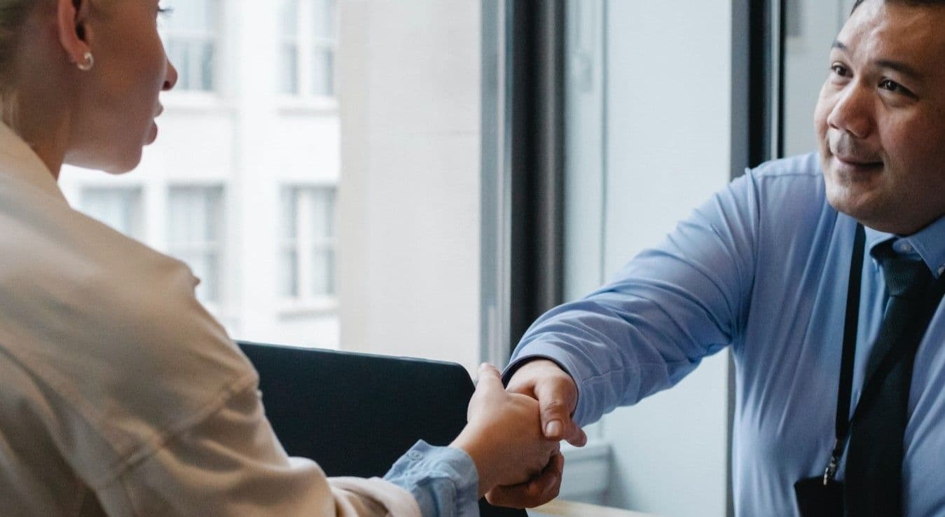 Man and woman shaking hands to close a deal