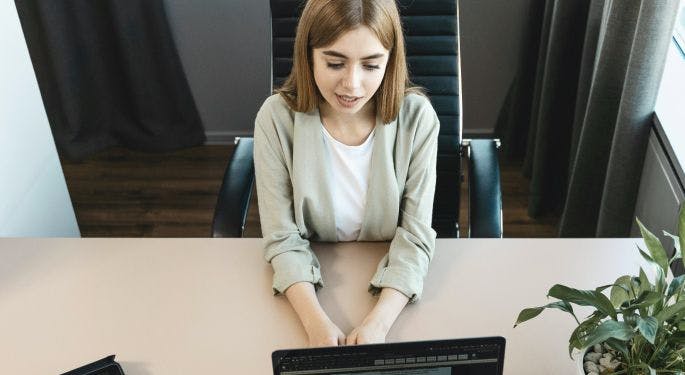 A woman interviewing over a computer. 