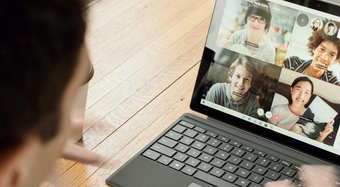 Man participating in a teleconference using his computer