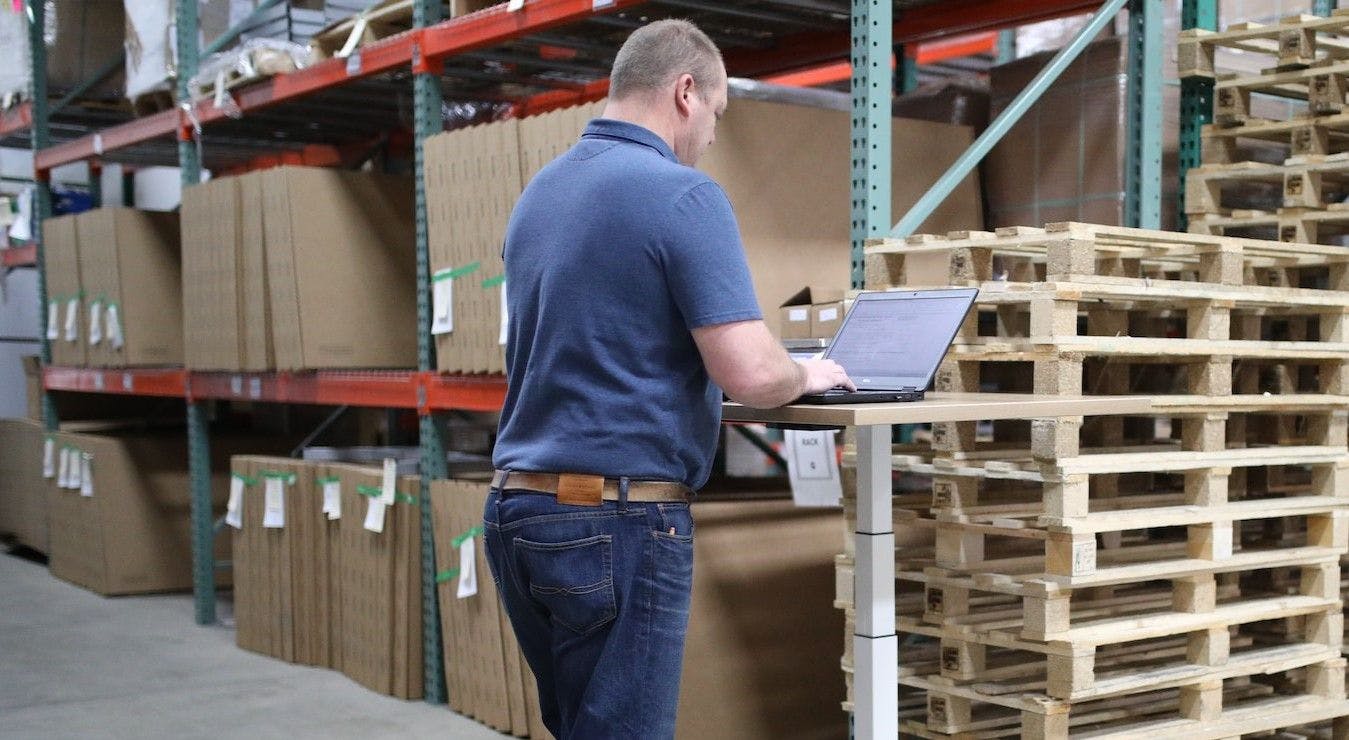 Man using computer in warehouse