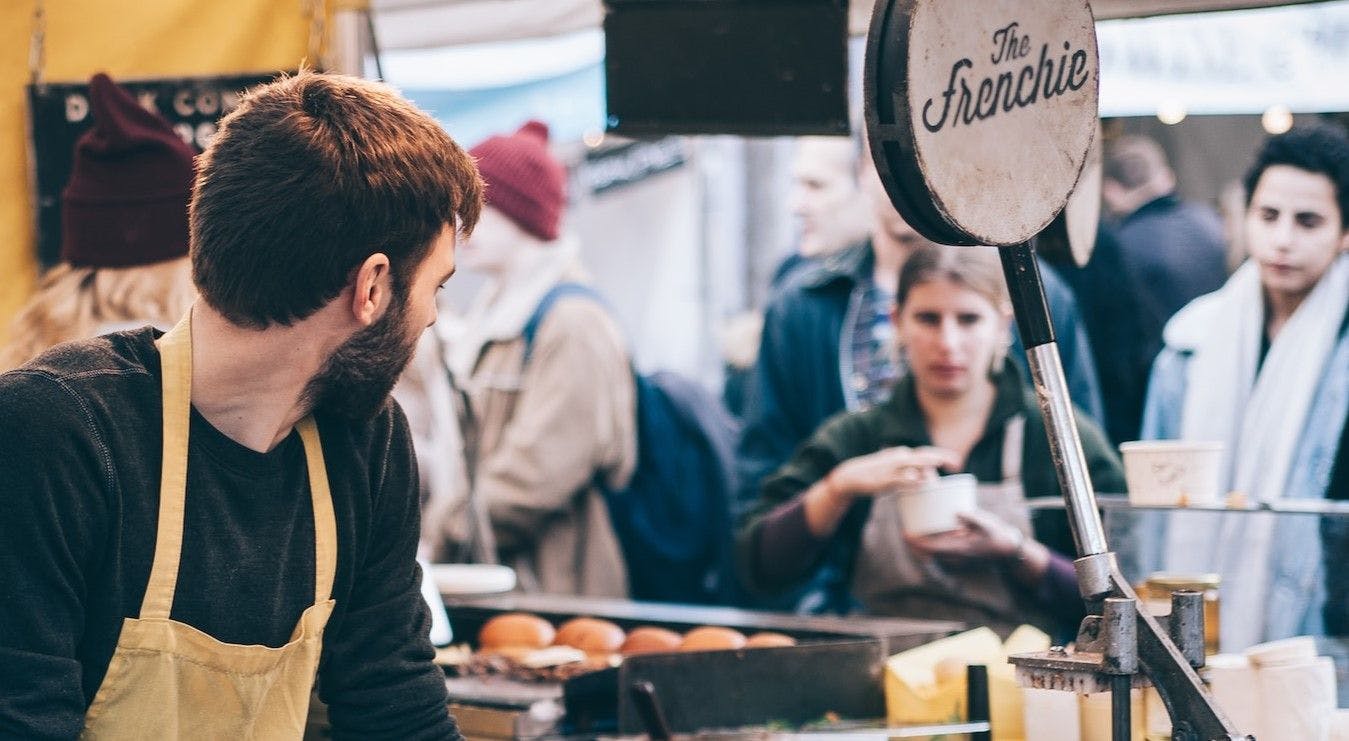 Employee looks over shoulder at a difficult customer