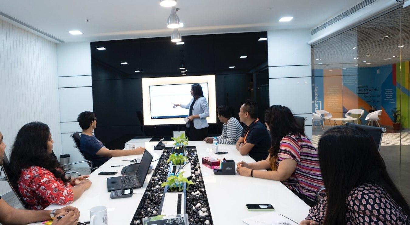 A professional speaker delivering a presentation to an attentive audience in a conference room.