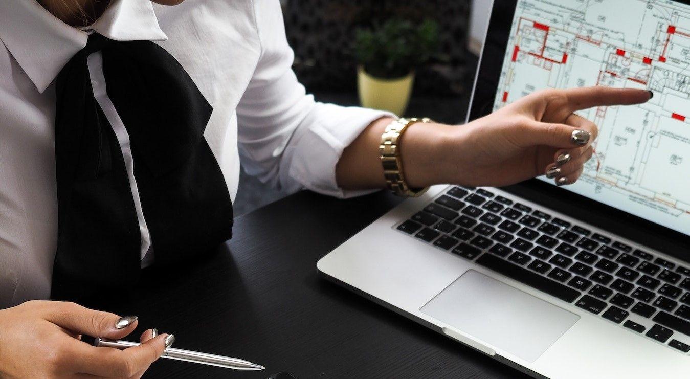 Woman point to event information on computer screen