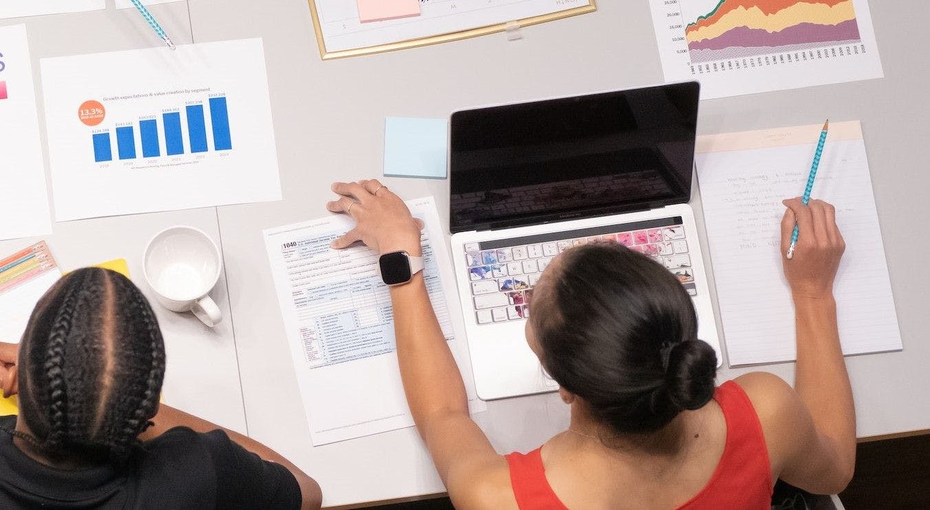 Two women looking over data and making decisions