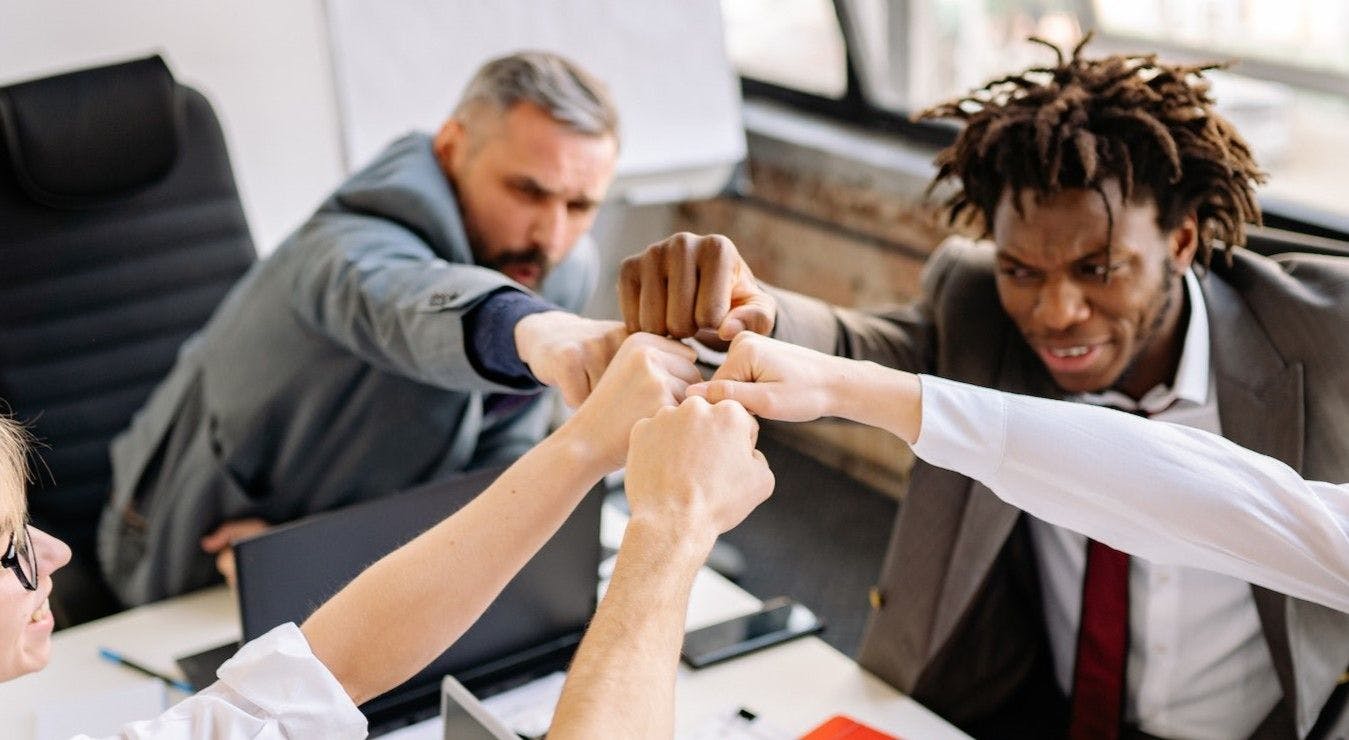 Business team putting hands together as a team